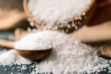 Pour salt into a wooden spoon, close-up