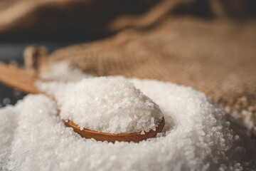 Wooden spoon with salt, close-up
