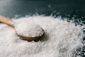 Wooden spoon with salt, close-up