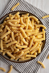 Raw Dry Organic Italian Fusilli Corti Bucati in a Bowl, top view. Close-up.