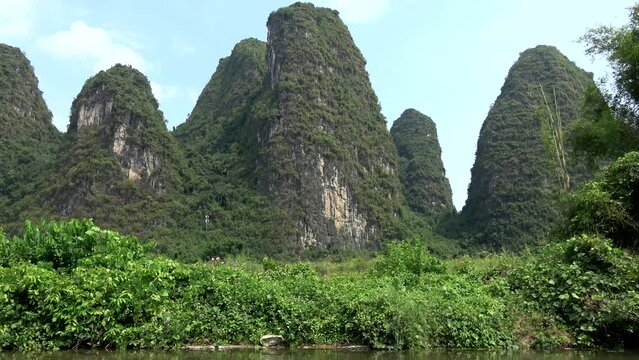 Home-made bamboo raft on Li River in China view of karst peak mountains a UNESCO World Heritage Site since June 2007 spans provinces of Chongqing Guangxi Guizhou and Yunnan known for its biodiversity