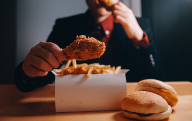 close up focus woman hand hold fried chicken for eat,girl with fast food concept