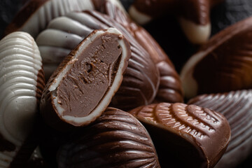 Chocolate candies in the shape of shells on a dark background
