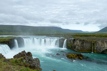 Iceland Akureyri landcape with waterfall on the river on a sunny day