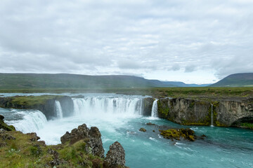 Iceland Akureyri landcape with waterfall on the river on a sunny day