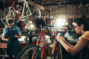 People, bicycle mechanic and fix with inspection for maintenance or small business at repair shop...
