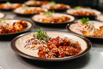 Tasty Korean BBQ chicken with coleslaw and sesame seeds, beautifully plated, for a delightful dining experience