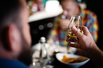 Person holding a whisky glass