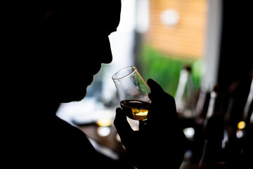 Person holding a whisky glass
