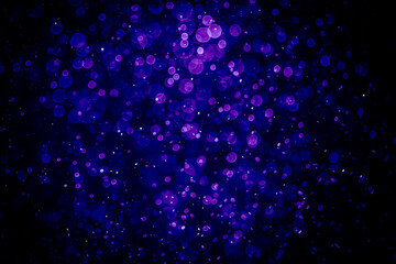 Blurred photo with purple violet and blue dots visible glittering, shining brightly look and feel luxurious