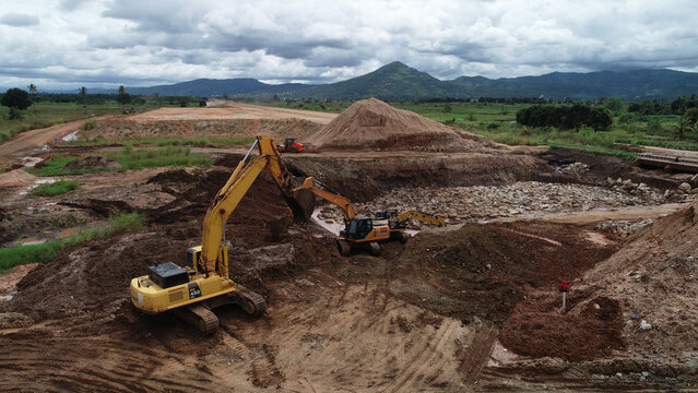 Aerial top view of excavator working in construction site