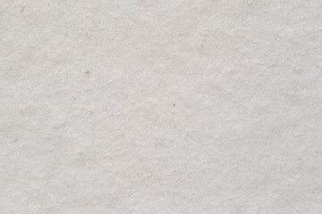White rough cardboard paper texture background with imperfections, high detailed backdrop. Closeup macro shot
