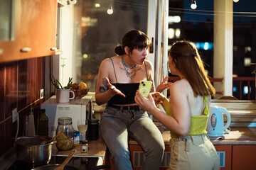 Young lesbian couple arguing in the kitchen at night