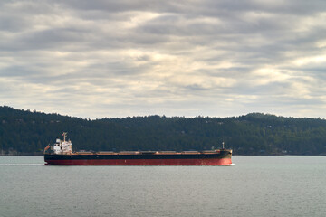 Cargo Freighter in the Gulf Islands BC. An international freighter travelling through the Gulf Islands between Vancouver and Victoria in British Columbia.

