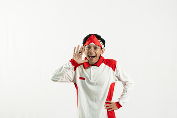 asian young man posing with his index finger, celebrating independence day 17 august, independence day concept, isolated white background. the man's hand was raised in a celebratory gesture 