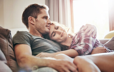 Fototapeta premium Couple, relax and home in lounge, love and cozy in marriage, embrace and peace in break and morning. House, man and woman on sofa, together and rest in living room, bonding and smile for relationship