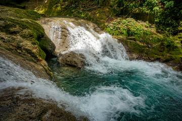 Blue Hole Waterfalls in Jamaica, pristine beautiful falls with vibrant blue and green colors.