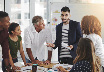 People, creative and business conversation in office, documents and collaboration together for brainstorming. Planning, company and goals or strategy idea with professionals in meeting with employees