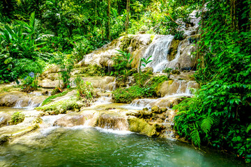 Konoko Falls in Jamaica known for its 4 different sets of falls and ,multi-step formation, with...