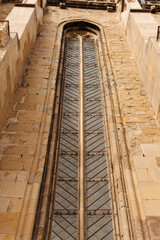 A detailed view of a narrow vertical window on a Gothicstyle cathedral displaying intricate designs