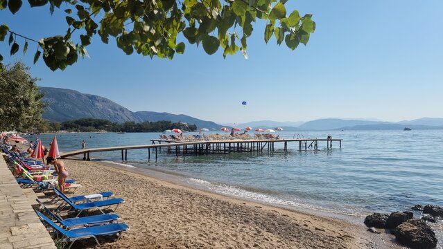 corfu island dassia beach tourist playing on the beach and the sea