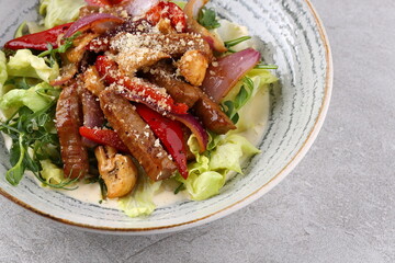 Beef steak salad with cherry tomatoes, cucumbers, red onions, romaine salad and lime mustard olive oil salad dressing