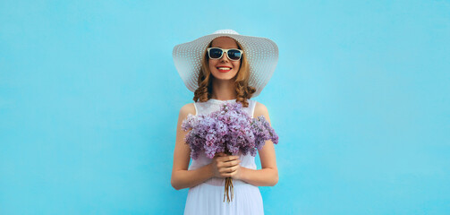 Summer beautiful lovely happy smiling woman with bouquet of purple lilac flowers in white straw hat