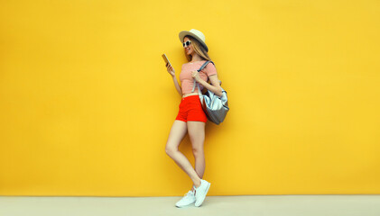 Summer vacation, tourism, happy traveler young woman tourist holding phone in hat with backpack
