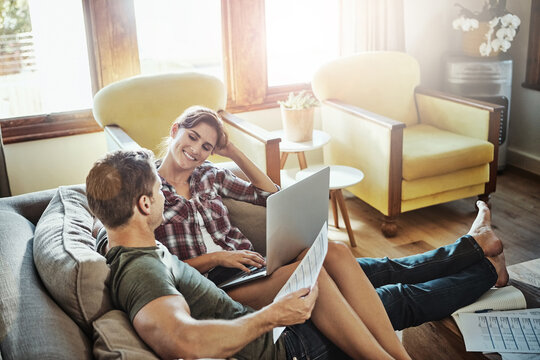 Couple, laptop and love in living room, paperwork and document of loan, marriage and home in weekend and morning. House, man and woman on sofa, bills and together in lounge, couch and happiness