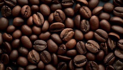 Fototapeta premium Close-Up Dark Roasted Coffee Beans on Coffee Beans Background, Scattered Close-Up View