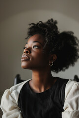 Obraz premium African American Woman Looking Thoughtfully Upward on Gray Background