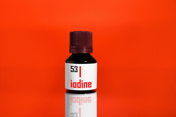 Bottle of medical iodine on red background