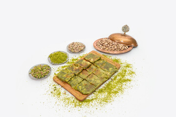 Traditional Turkish dessert Katmer with clotted cream and dough on wooden board isolated on white...