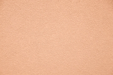Peach fuzz textured surface, closeup. Trendy shade of 2024 year