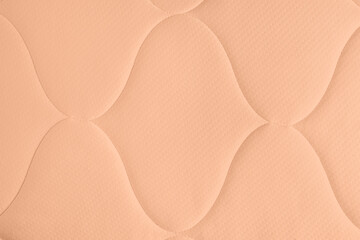 Peach fuzz color textile surface, closeup. Trendy shade of 2024 year