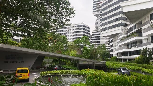 Sinngapore city, Singapore - 16th march, 2023: DHL can arrive delivers postage. The Interlace Condominium in Singapore. Eco friendly and sustainable buildings Asia