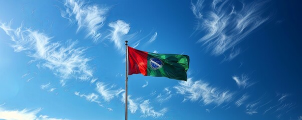 Portugal flag waving against a bright, blue sky