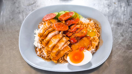 Crispy pork rice on a blue plate on the dining table