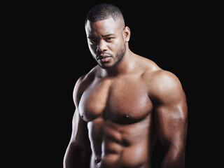 Fototapeta premium Black man, portrait and strong in studio for exercise, strong bodybuilder or training for wellness. Male athlete, dark background and healthy for shirtless workout, stomach with muscle for gym sport