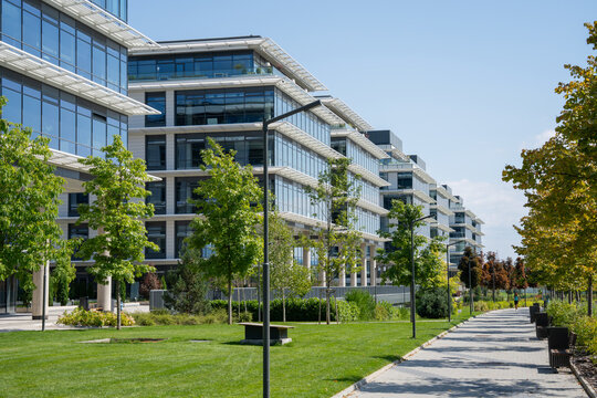 Modern commercial buildings and a beautiful walkway in Europe on a sunny day