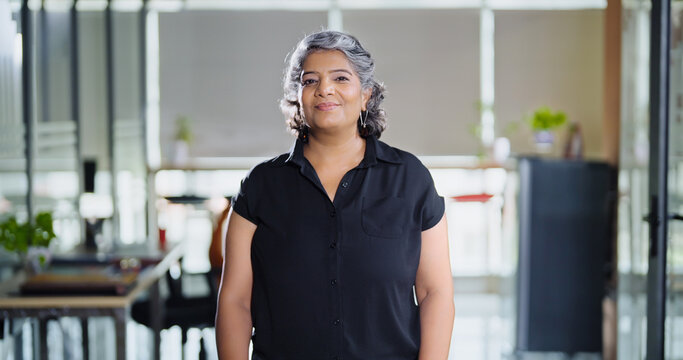 Indian Asian happy older aged adult boss ceo woman lady agent look cam do pose head shot video elder old gen x healthy female leader worker staff expert standing proud indoor job office work place day