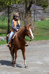 A woman riding her quarter horse
