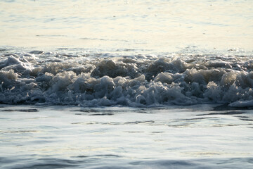 View of the surf on the beach during sunset