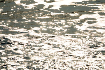 View of the surf on the beach during sunset