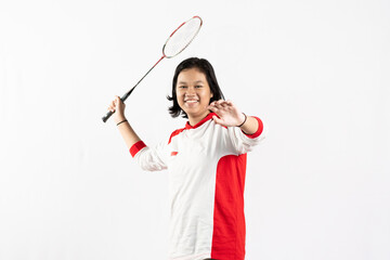 Young Asian woman wearing Indonesian clothing is holding a racket and playing badminton. isolated white background