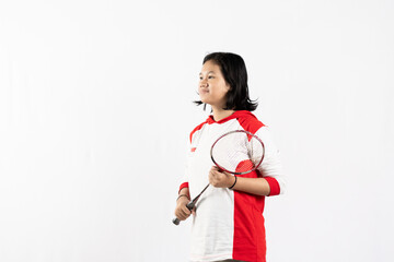 Young Asian woman wearing Indonesian clothing is holding a racket and playing badminton. isolated white background