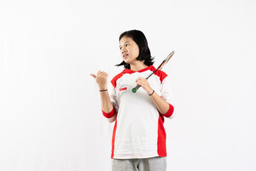 Young Asian woman wearing Indonesian clothing is holding a racket and playing badminton. isolated white background