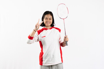 Young Asian woman wearing Indonesian clothing is holding a racket and playing badminton. isolated white background