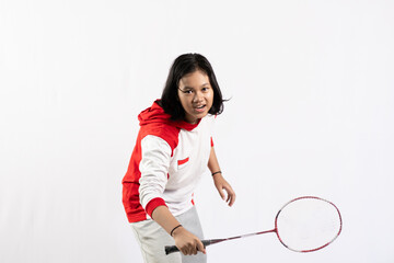 Young Asian woman wearing Indonesian clothing is holding a racket and playing badminton. isolated white background