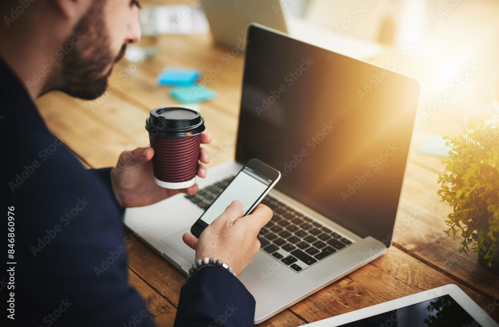 Aufkleber Coffee, phone and laptop with man at coworking desk with blank screen for social media break on tech. Morning, web designer and creative job with latte and mobile scroll at office with design work